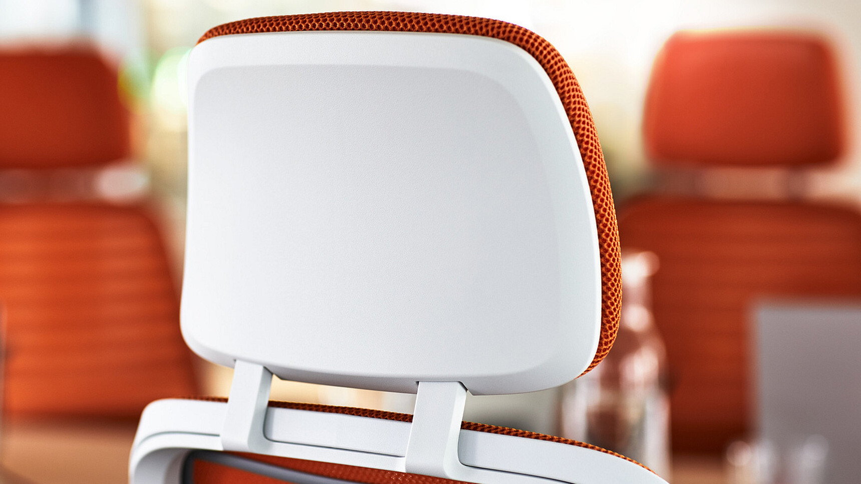 Three Steelcase Series One With Headrest Office Chairs In Orange Upholstery And White Frame Detail Image