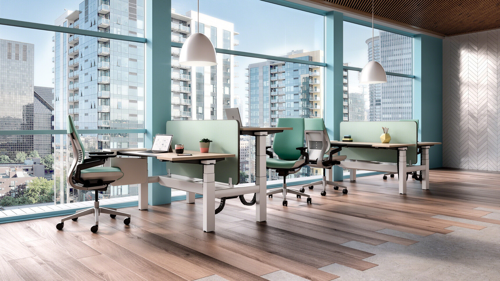 Two Steelcase Case Height Adjustable Desks With Wood Table Tops And White Legs And Green Fabric Screens With Four Gesture Wrapped Back Office Chairs In Green Upholstery At Desks