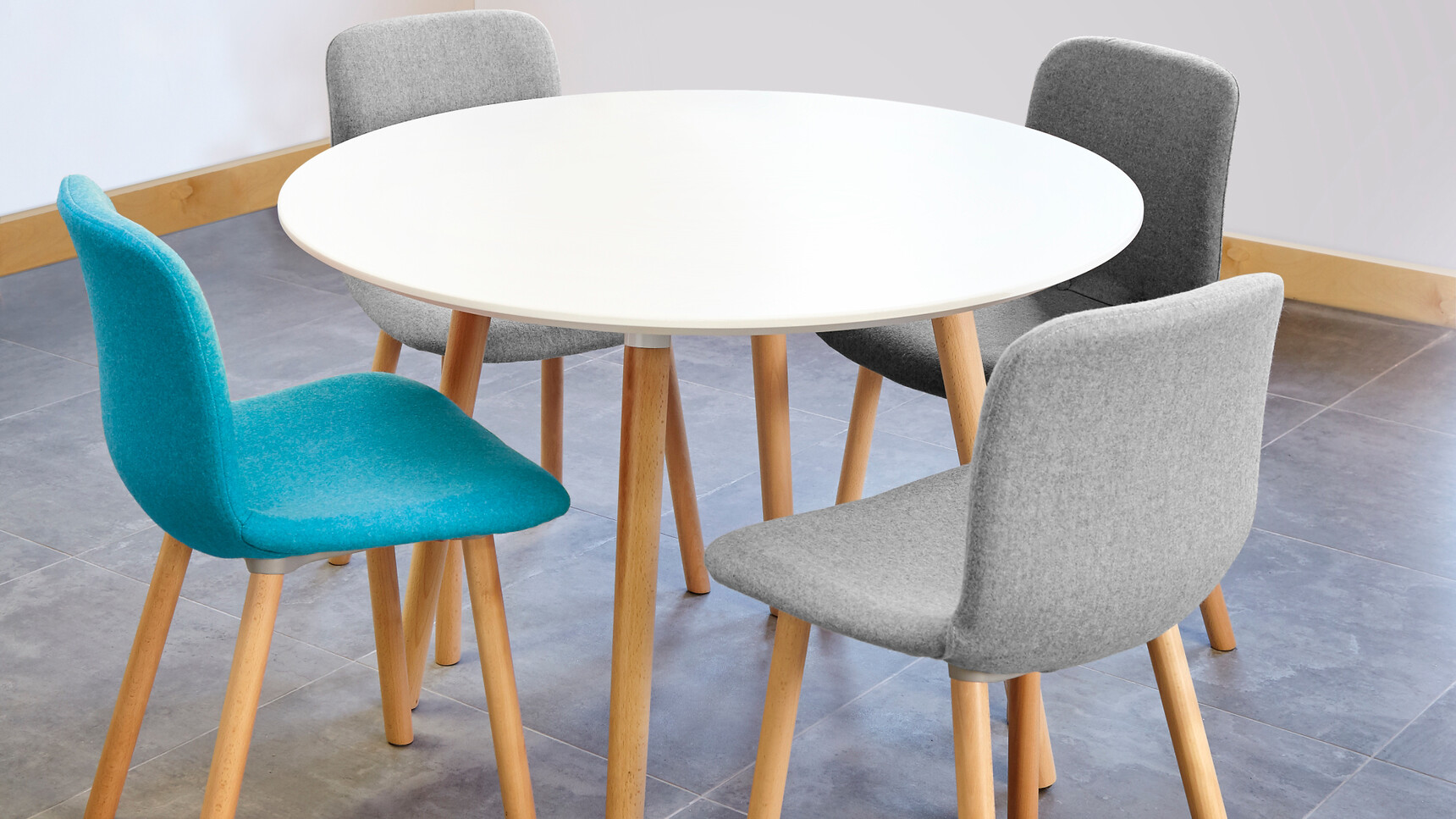 Elite Tondo Circular Meeting Table With White Table Top Finish With Wood Leg Finish With Four Ben Upholstered Chairs Two In Grey One Black And One Blue Upholstery At Desk
