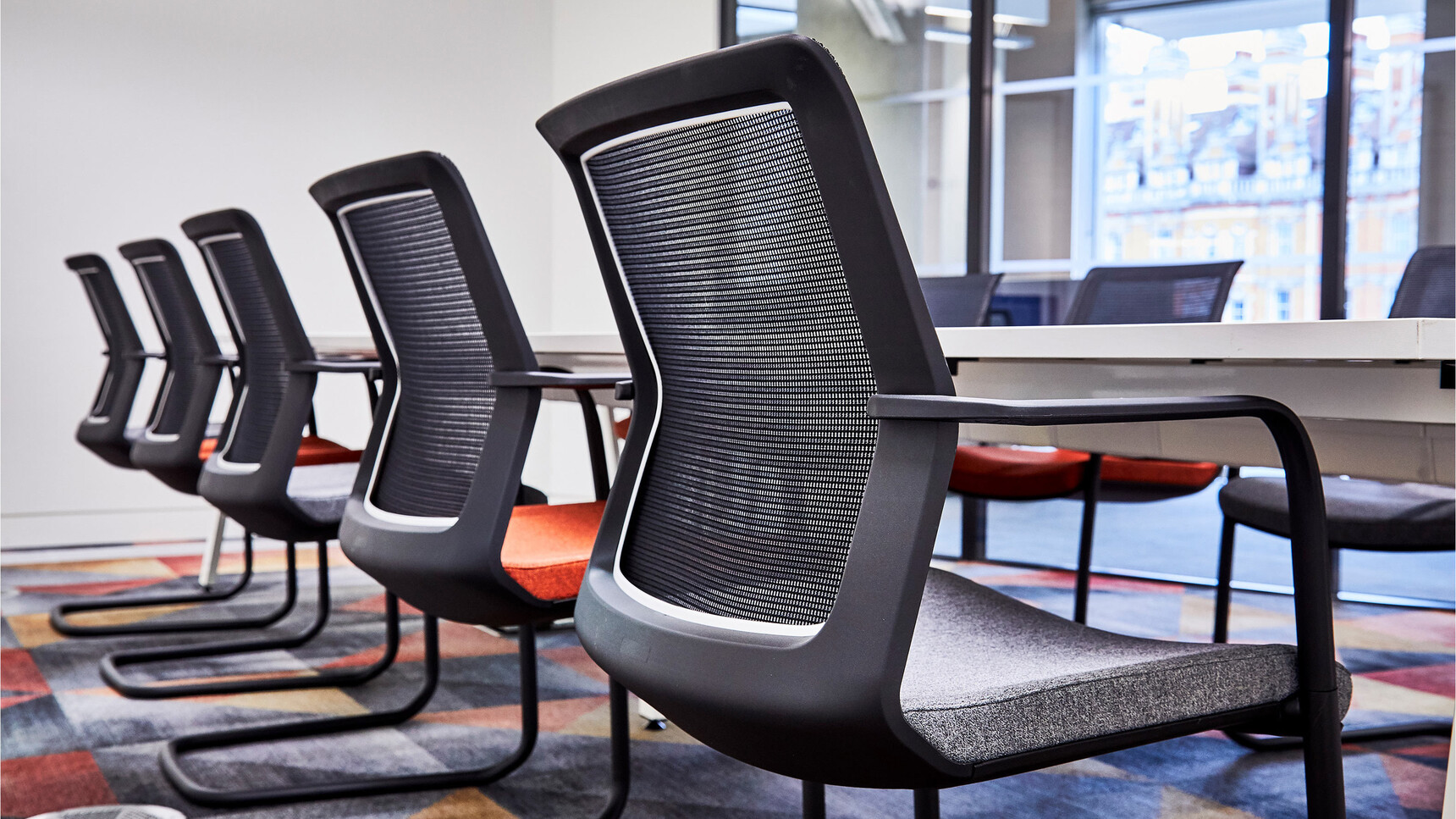 Orangebox Workday Cantilever Armchairs With Black Legs And Backrest At Table Detail Image