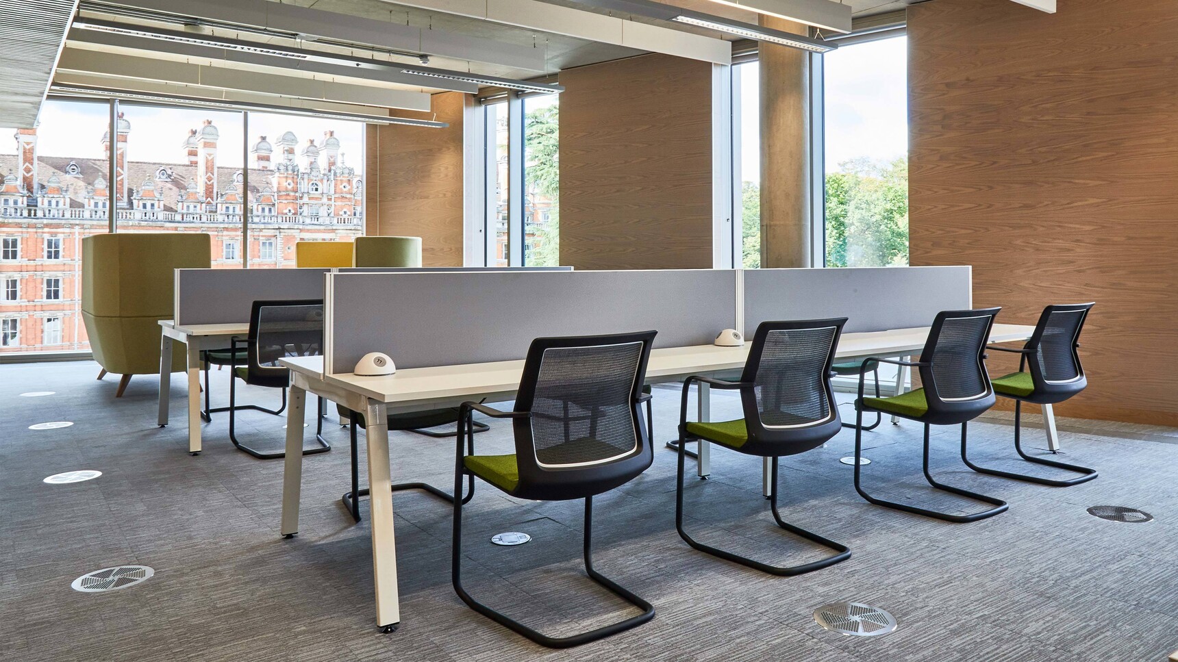 Orangebox Workday Cantilever Armchair With Dark Green Seat Upholstery With Black Leg Finish At Desks In Office Setting