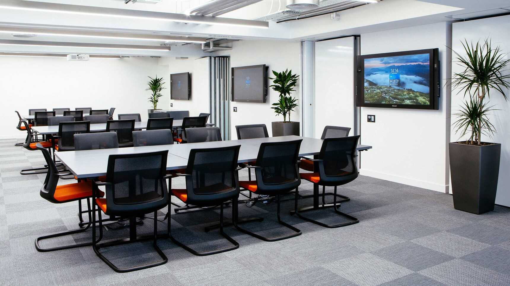 Orangebox Workday Cantilever Armchairs With Orange Seat Upholstery And Black Leg Finish At Meeting Tables
