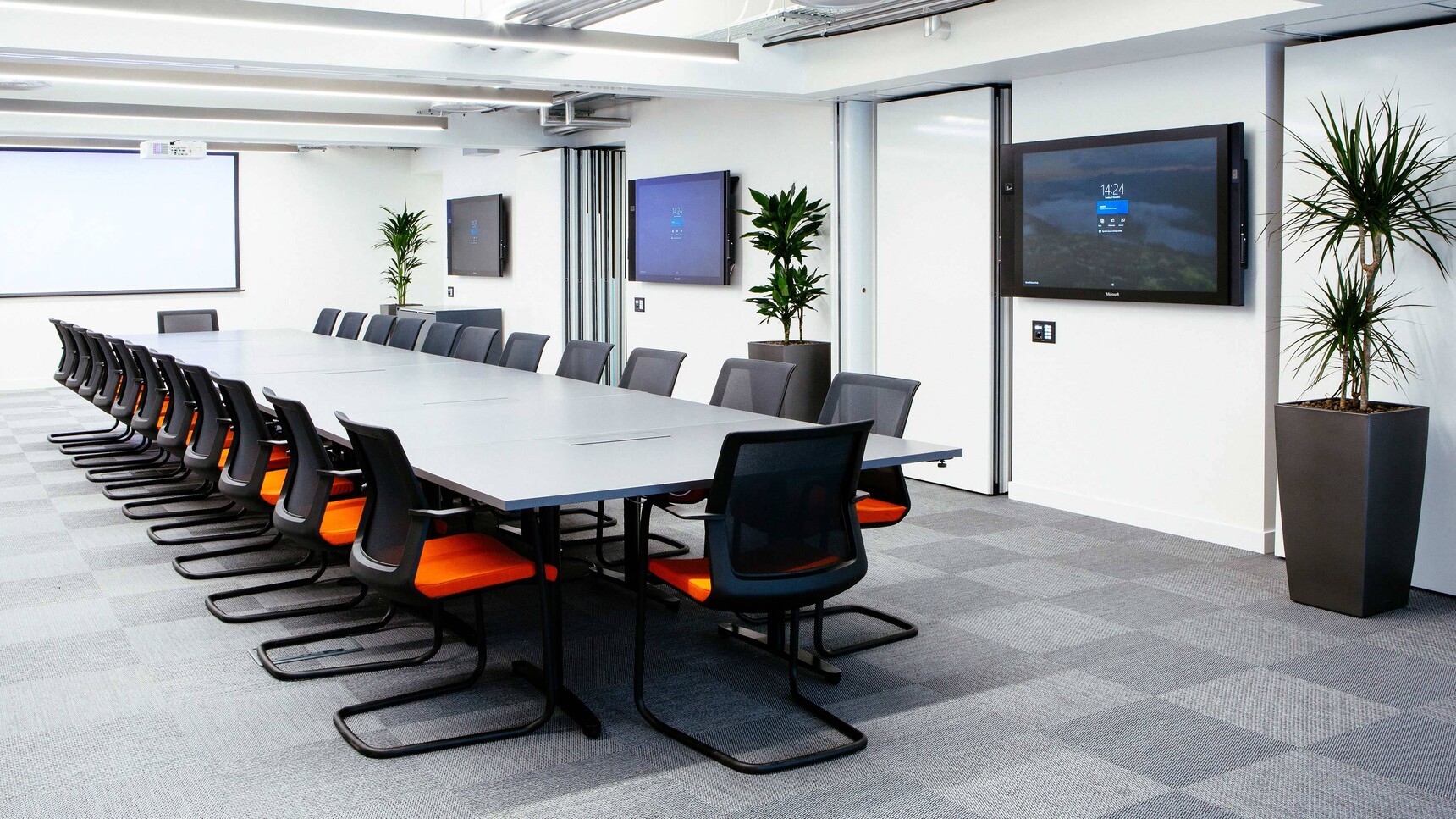 Orangebox Workday Cantilever Armchairs With Orange Seat Upholstery And Black Legs And Backrest Finish At Conference Table