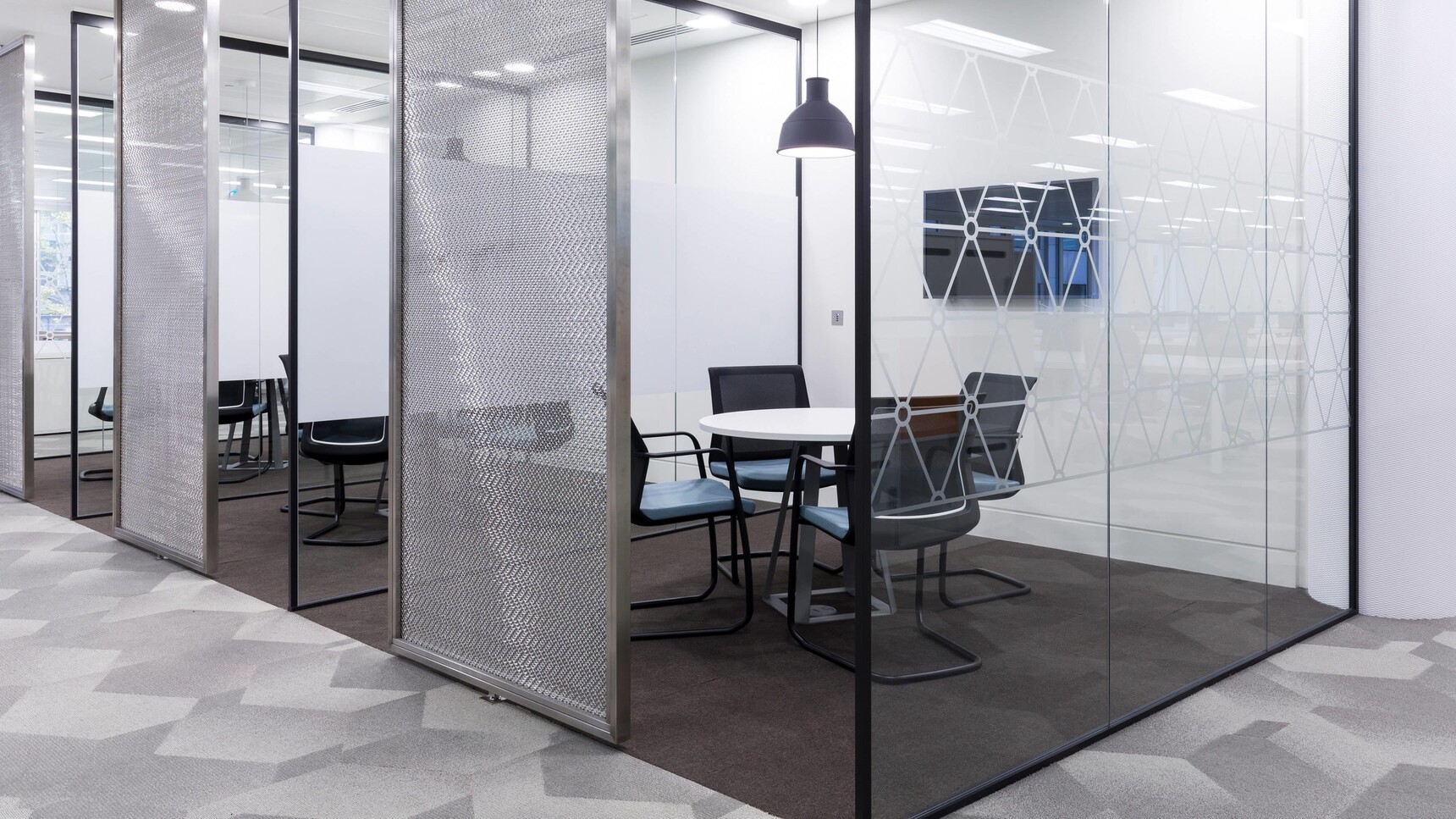 Orangebox Workday Cantilever Armchair With Blue Seat Upholstery And Black Legs At Meeting Table In Meeting Room