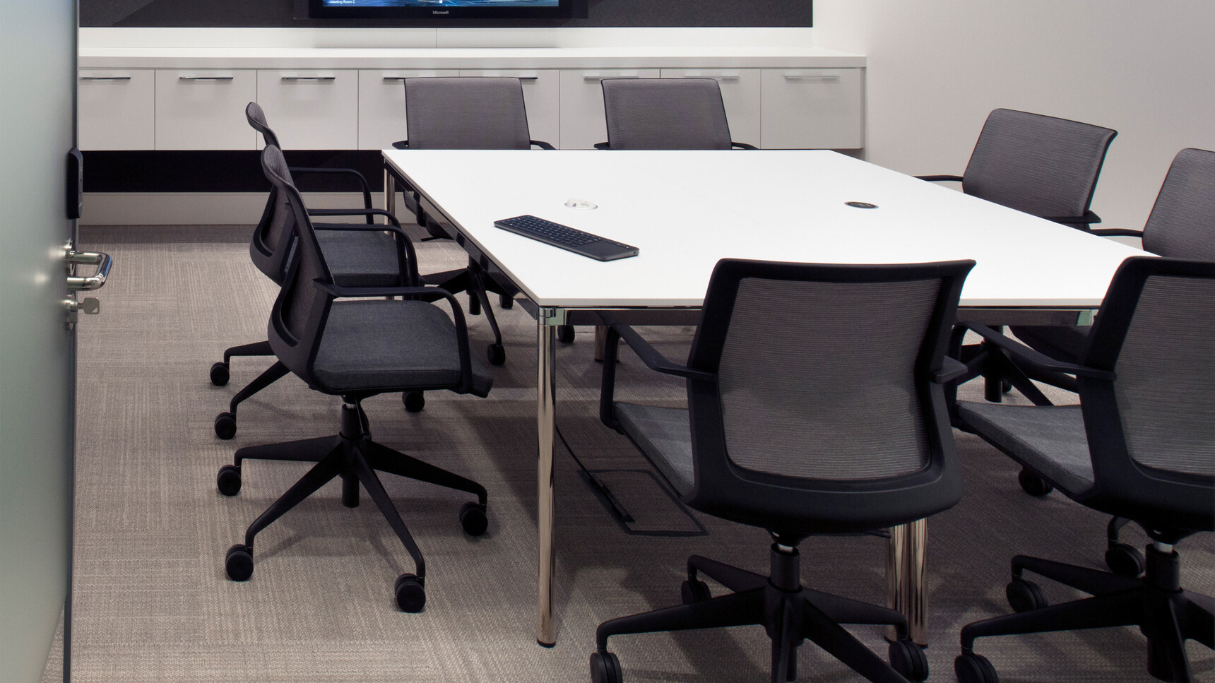 Orangebox Workday Lite Work Armchairs At Meeting Table With White Table Top In Meeting Room