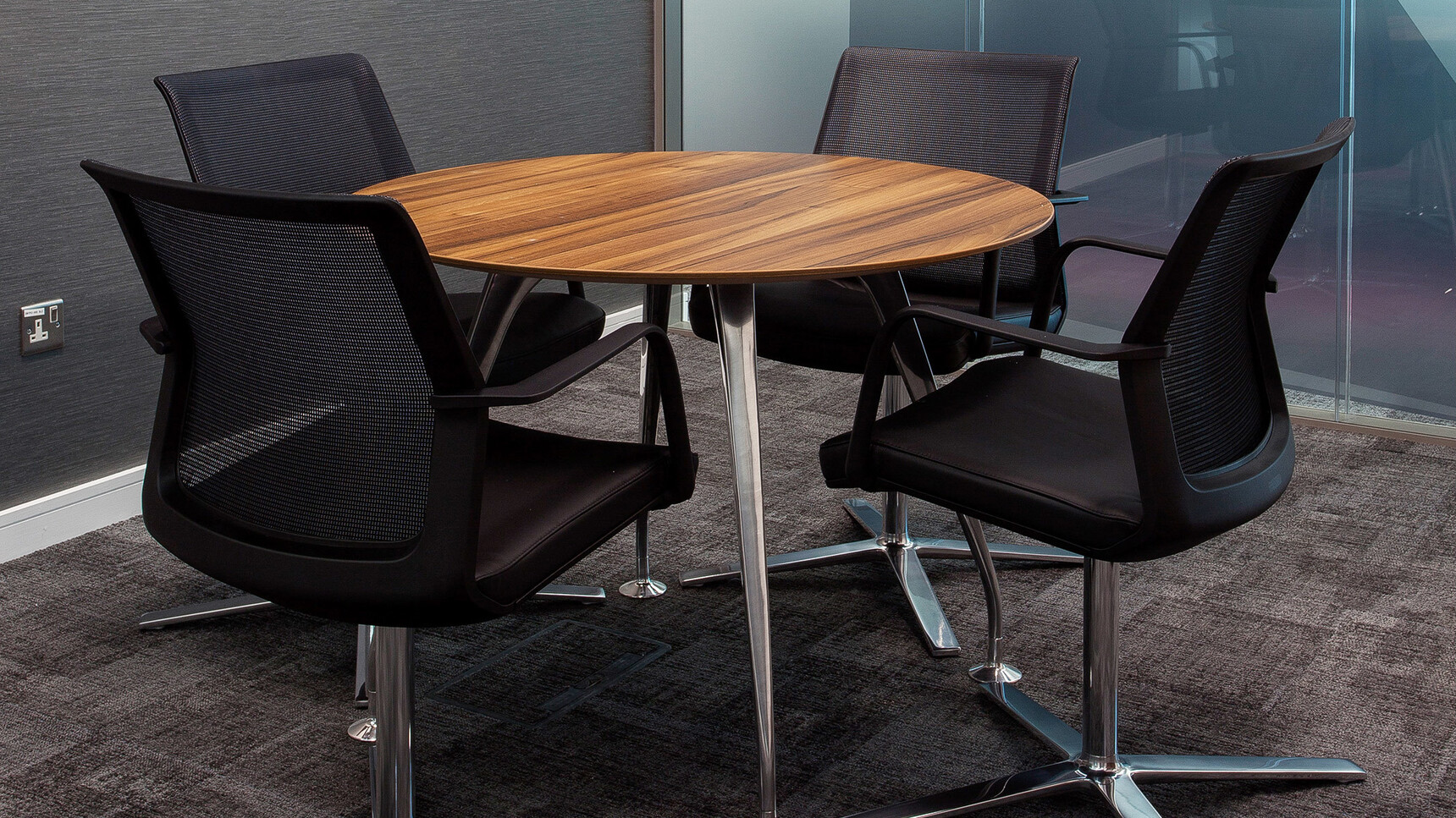 Orangebox Workday Conference Armchair In Black Upholstery And Frame With Polished Base At Meeting Table