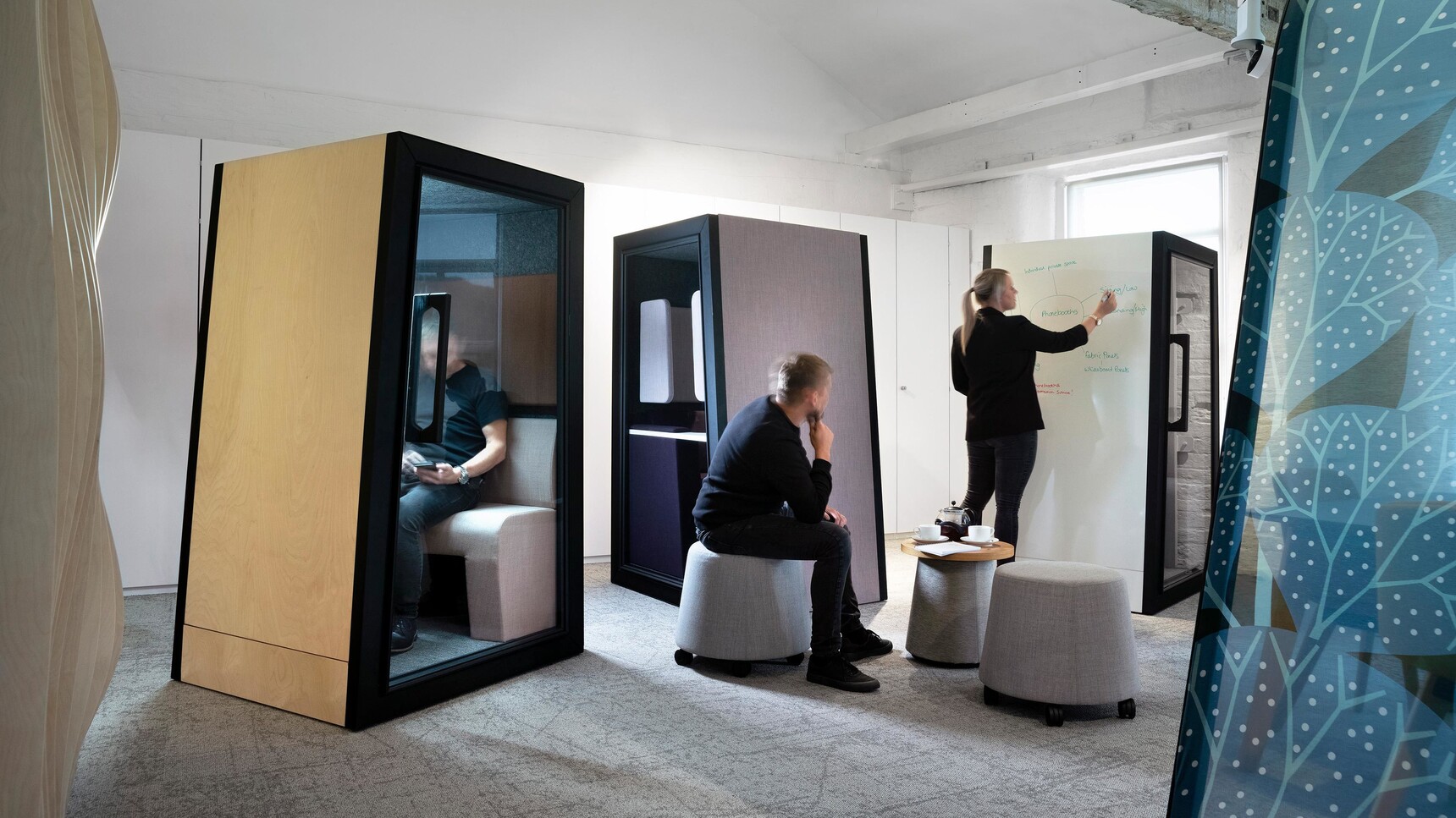 Orangebox On The QT Personal Pods In Different Finishes In Use In Brainstorming Session