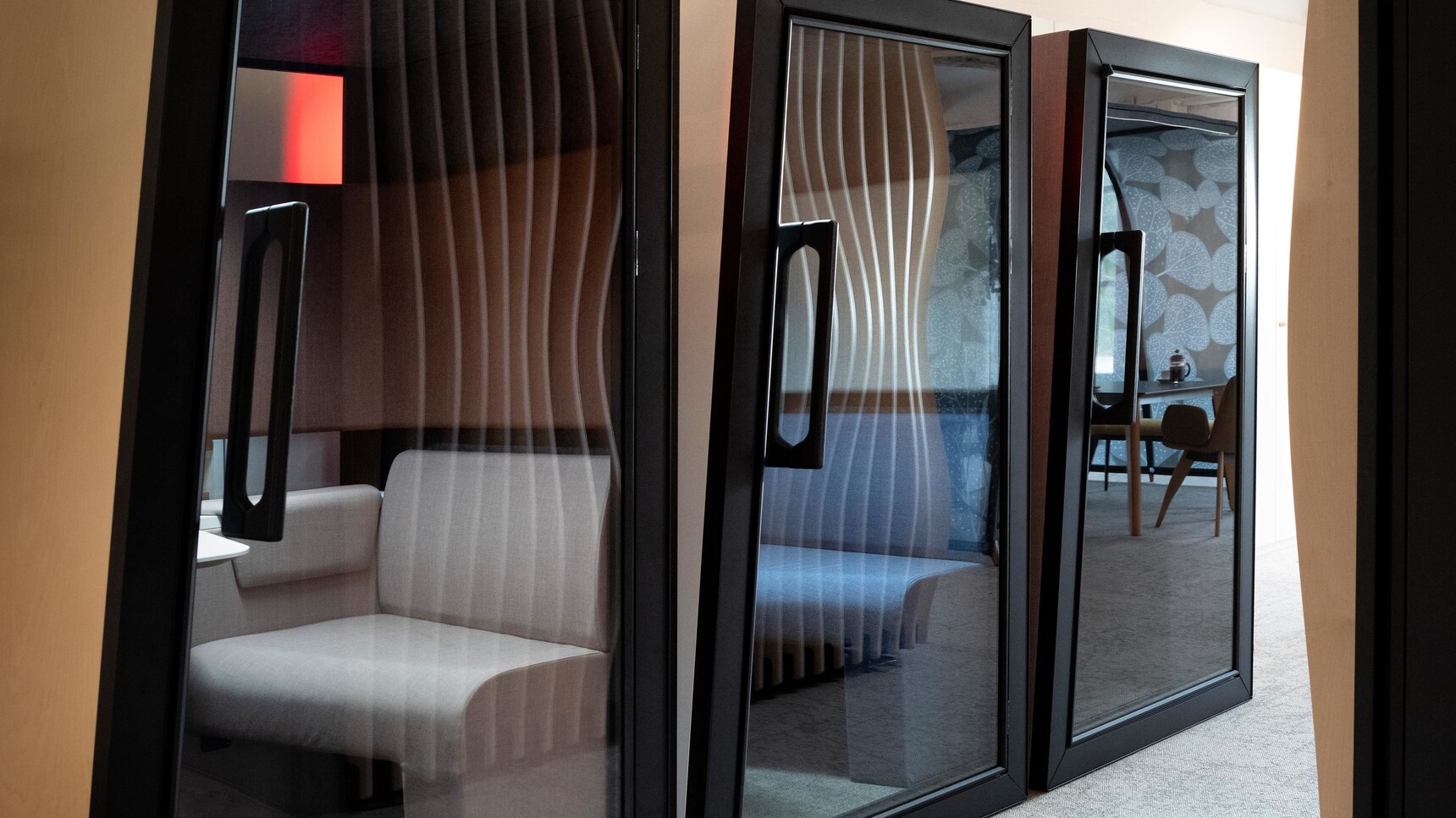 Orangebox On The QT Personal Pods In Wood And Black Finish In Row In Office Environment