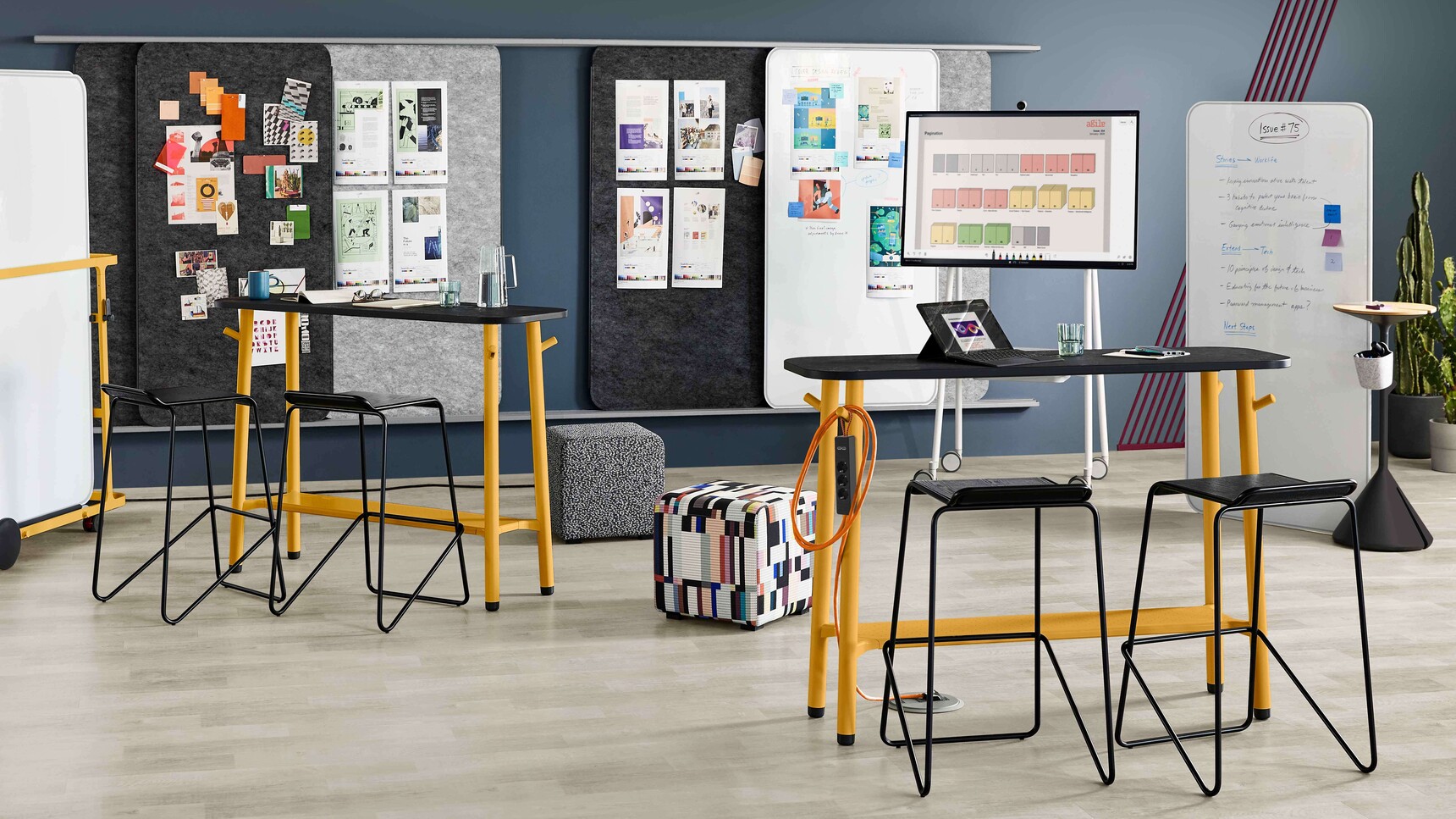 Steelcase Flex Tables With Black Top Finish And Yellow Leg Finish With Acoustic Screens And White Boards In Office Setting