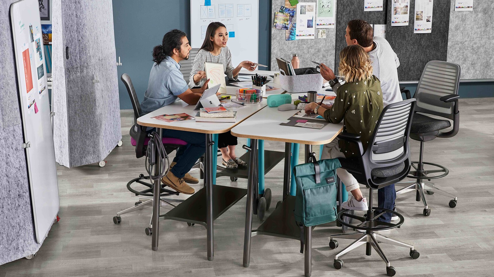 Steelcase Flex Tables With White Table Top And Black Legs In Use With Acoustic Screens And Series 1 Chairs At Tables In Office Setting