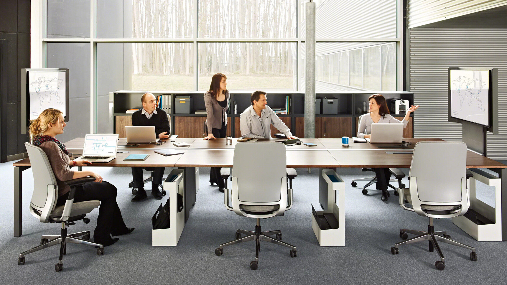 Six Steelcase Amia Platinum Office Task Chairs At Wood Table In Use By Five People In A Office Environment