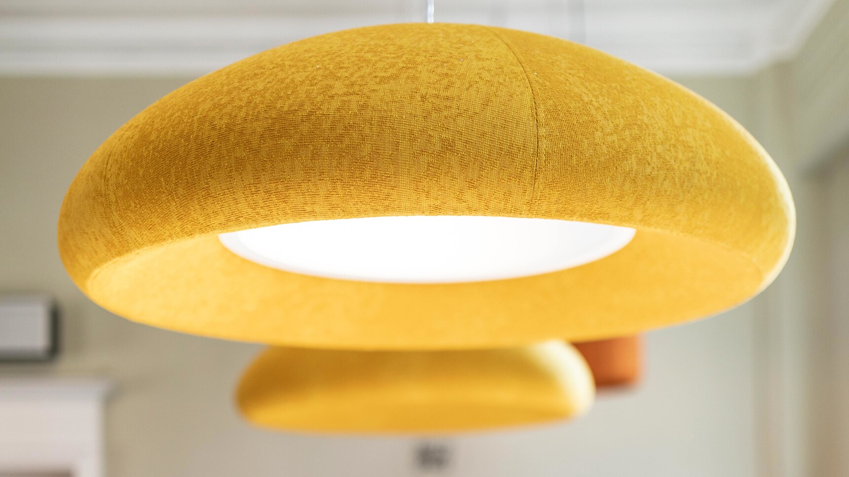 Two Buzzi Space BuzziDome LED Lights With Yellow Upholstery In Office Setting Detail Image