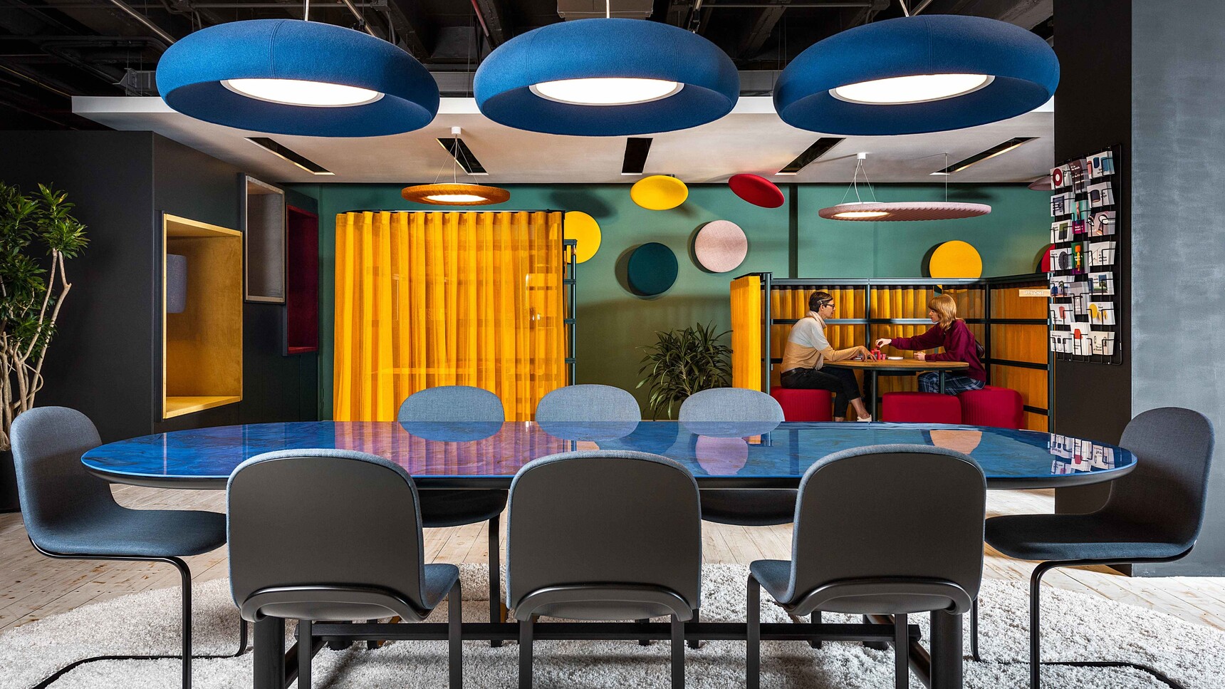 Three Buzzi Space BuzziDome LED Lights With Blue Finish Over Meeting Table In Office Setting