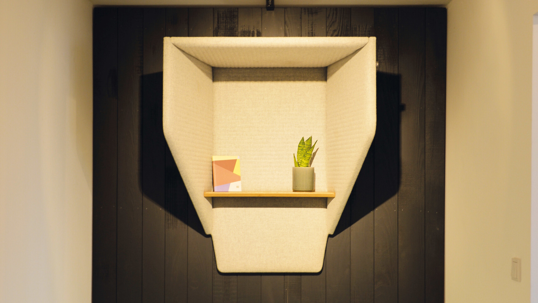 Buzzi Space BuzziHood Acoustic Element In White Upholstery Detail Image With Plant