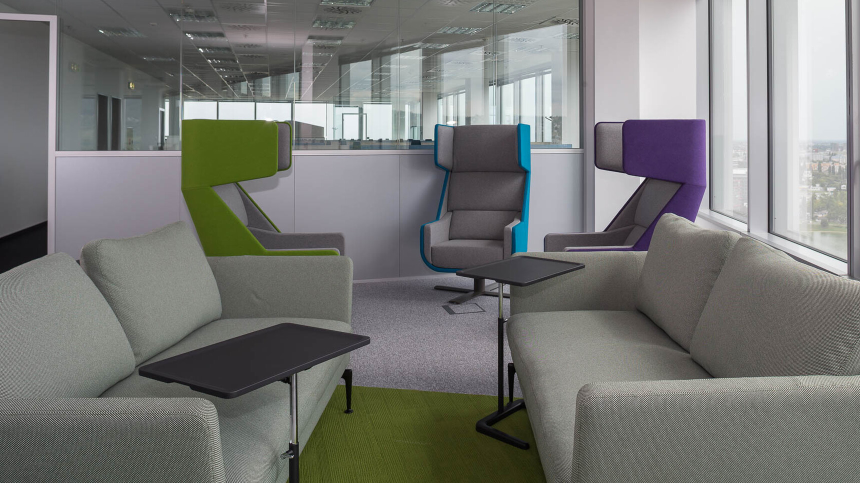 Three Buzzi Space BuzziMe Lounge Chairs In Various Colours In Office Setting