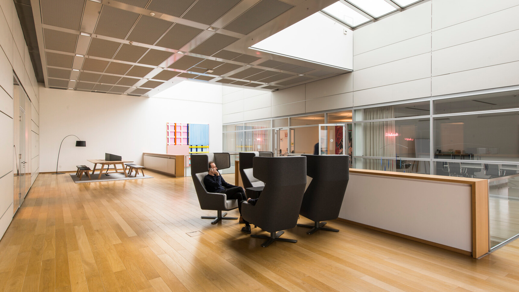 Four Buzzi Space BuzziMe Lounge Chairs In Grey And Dark Grey Upholstery In Office Environment