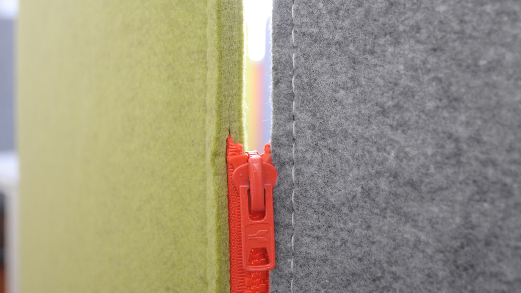 Buzzi Space BuzziScreen Acoustic Partitions In Green And Grey Upholstery Detail Image Of Orange Zipper