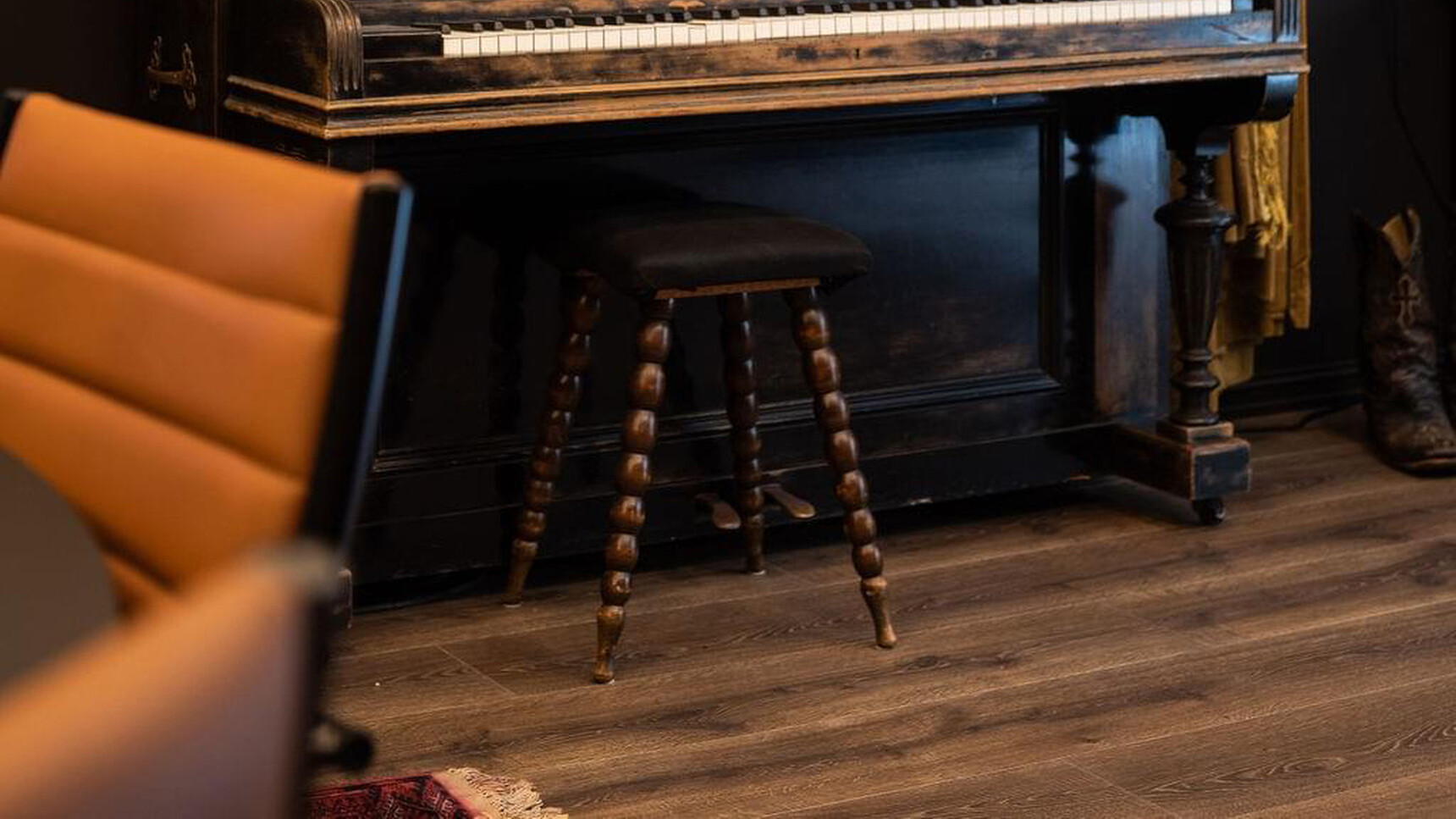 Sitland Classic Low Back Office Chair On Castors With Orange Upholstery At Meeting Table Detail Image With Piano