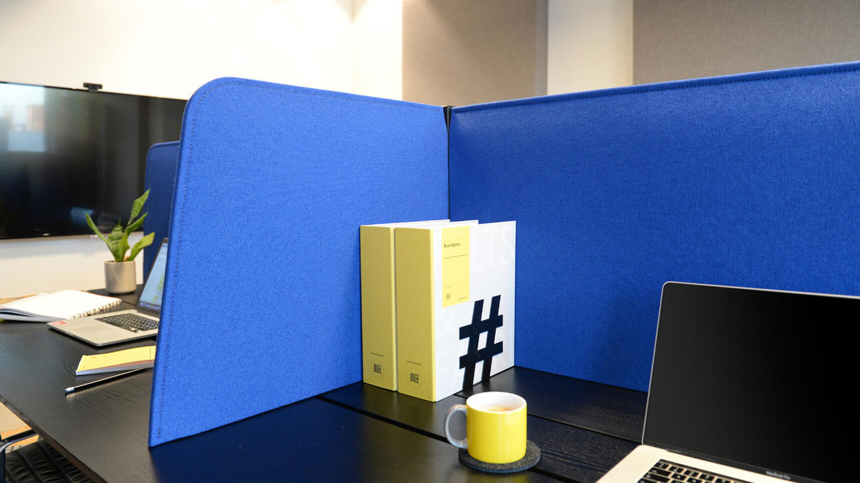 Buzzi Space BuzziDesk Cross Acoustic Desk Divider In Blue Upholstery Detail Image With Laptop