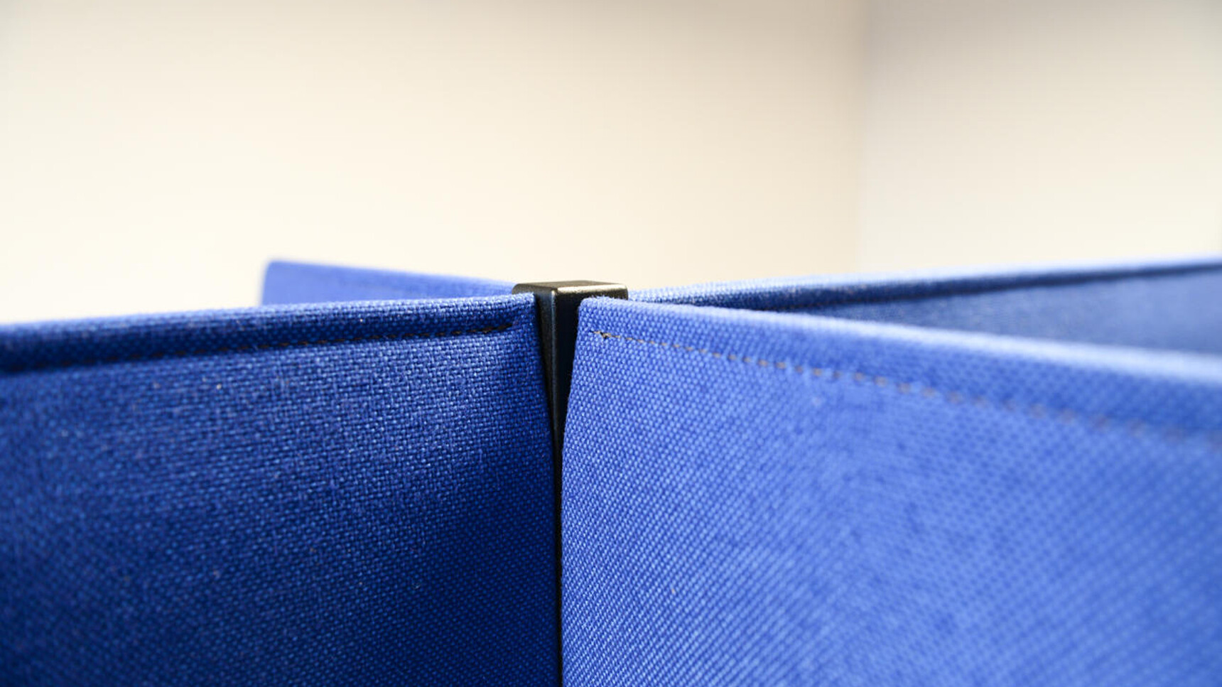 Buzzi Space BuzziDesk Cross Acoustic Desk Divider In Blue Upholstery Detail Image Of Fabric