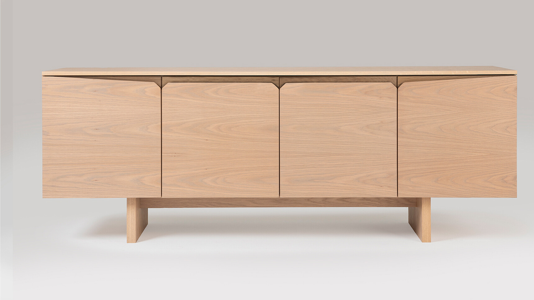 William Hands Vantage Credenza Slab Panel Base Four Doors Wood Finish Front Angle Family Image