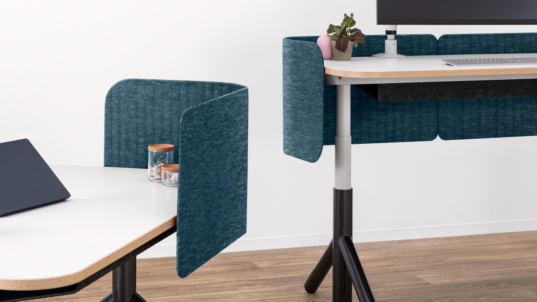 Two Steelcase Flex Height Adjustable Desks With White Table Top Finish And Black Leg Finish And Wood Edges With Privacy Screen In Dark Blue Upholstery Detail Image