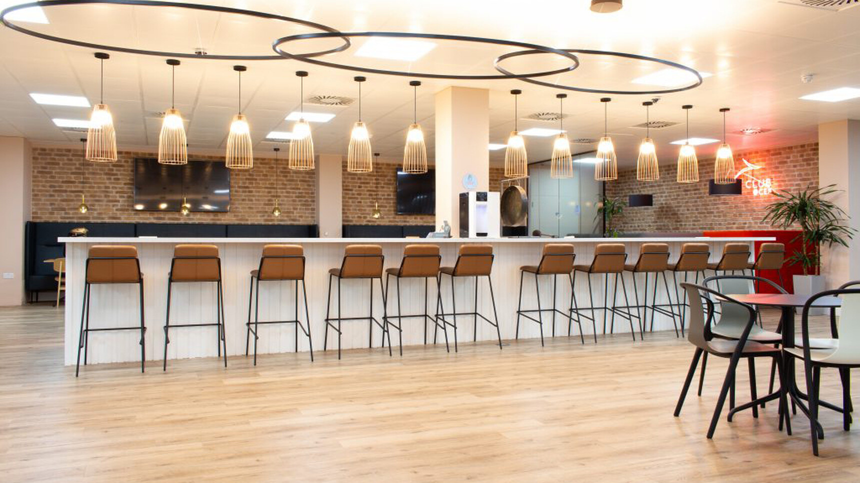 Workstories Sling High Upholstered Stool At Poseur Height Table In Office Environment