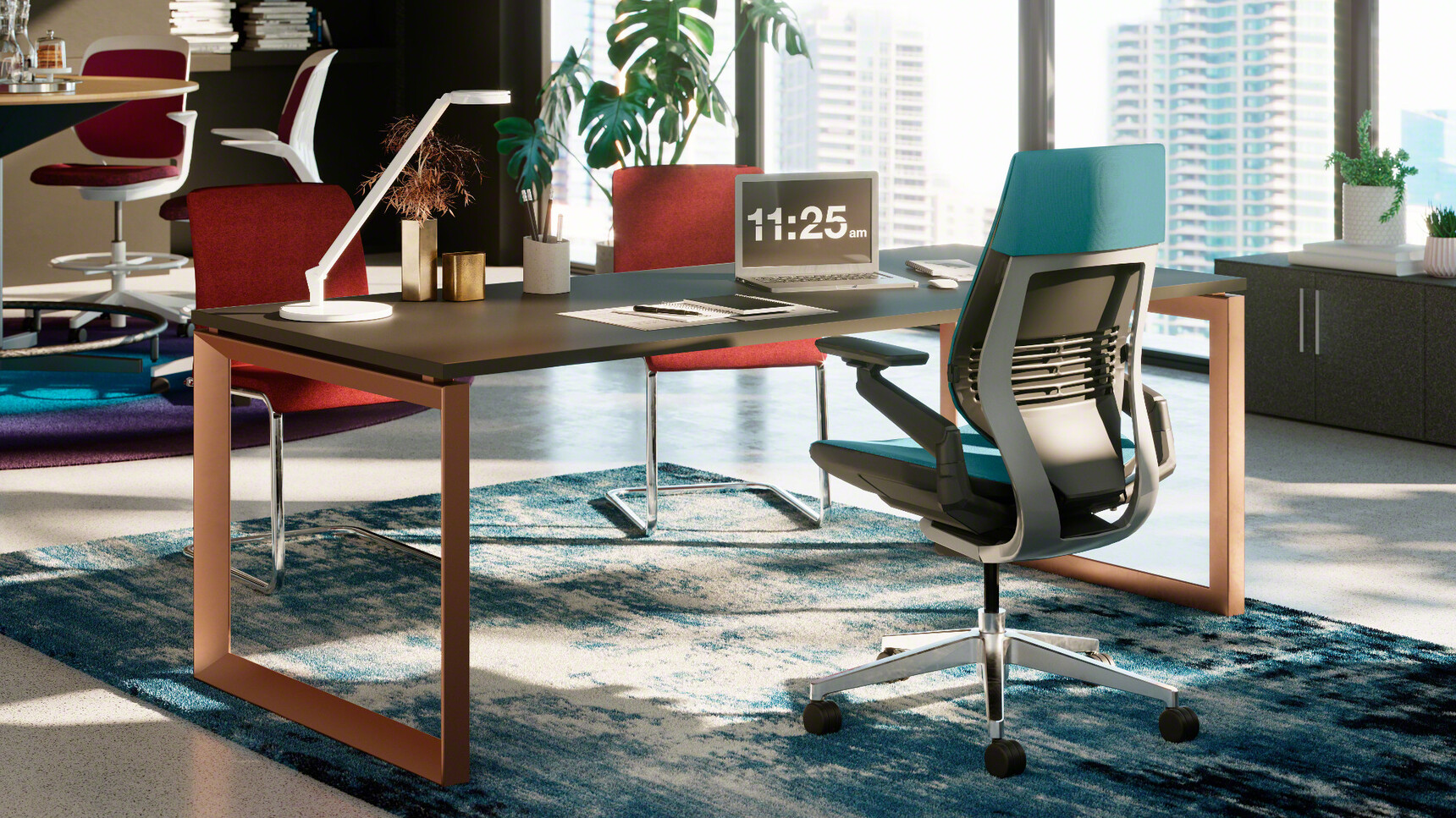 Steelcase Frameone Loop Leg Desk With Dark Wood Table Top Finish And Light Brown Loop Leg And Gesture Wrapped Back Office Chair With Blue Upholstery And Black Grey Frame And Polished Aluminium Base