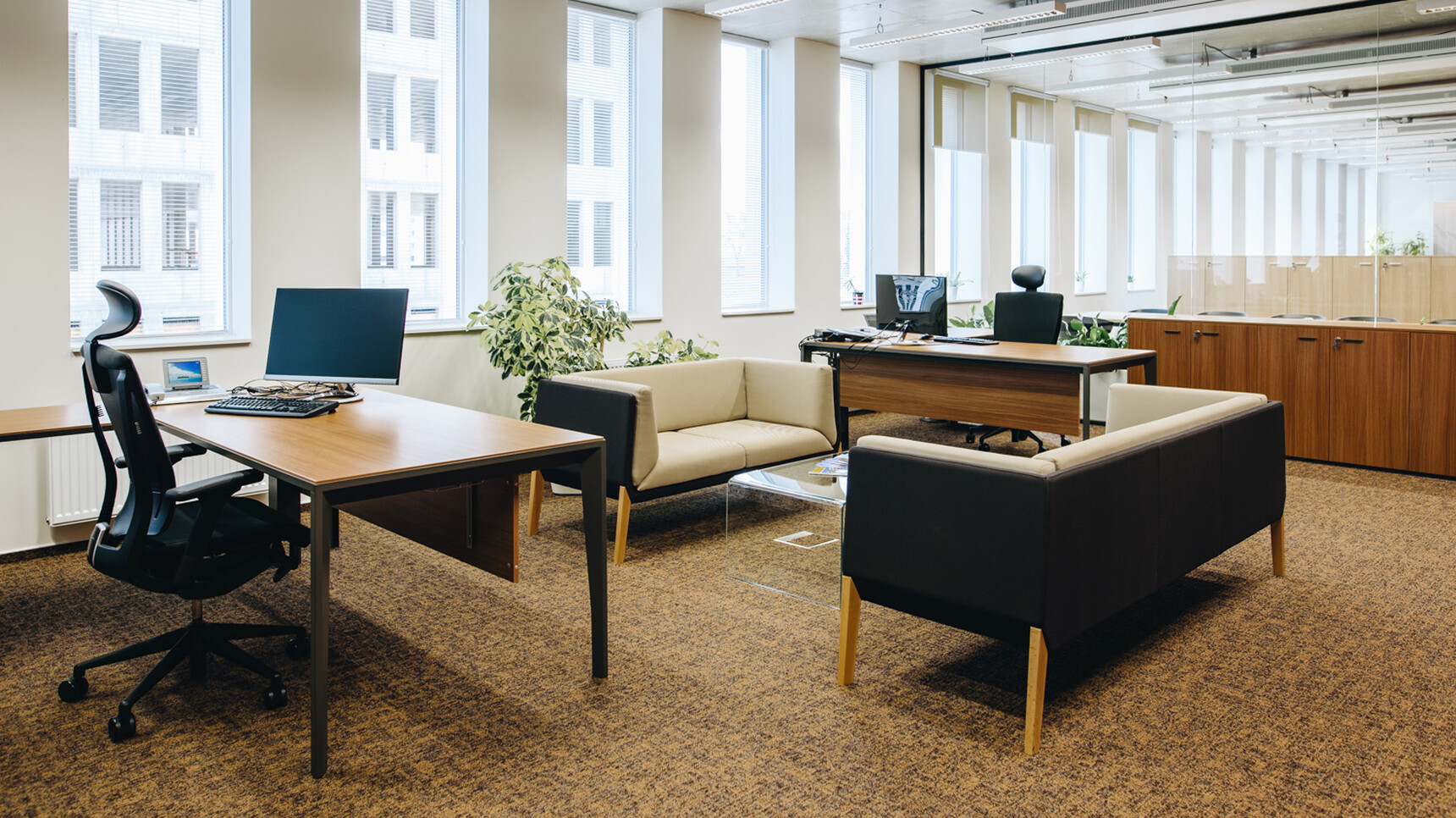 Two X5 Straight Desks 600mm Depth With Wood Finish With Modesty Panels And Black Leg Finish With Two Sofas At Coffee Table And Two Chairs At Desks