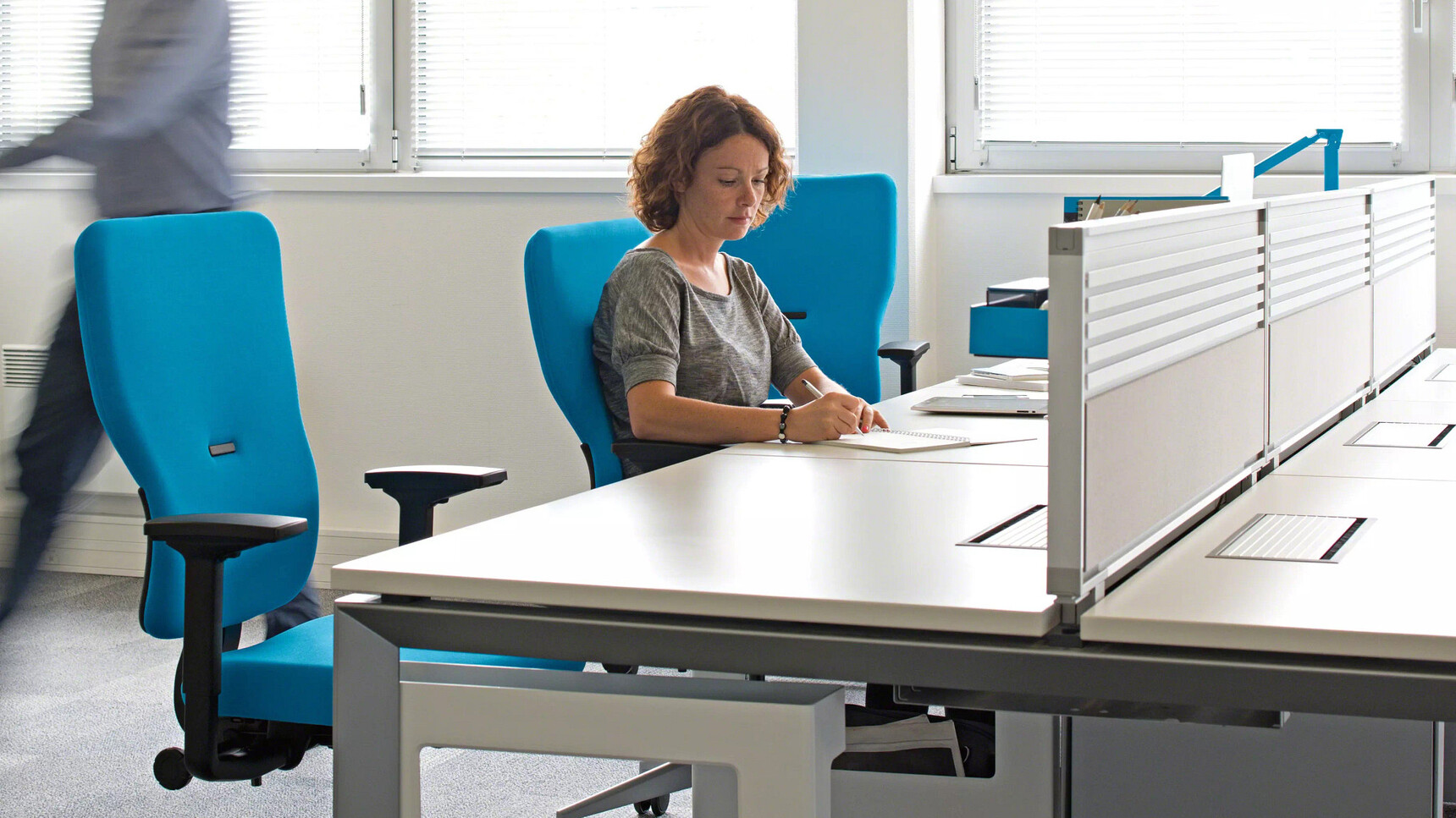 Steelcase Let's B High Back Office Chairs Blue Upholstery At Bench Desk With Woman on Chair In Office Environment