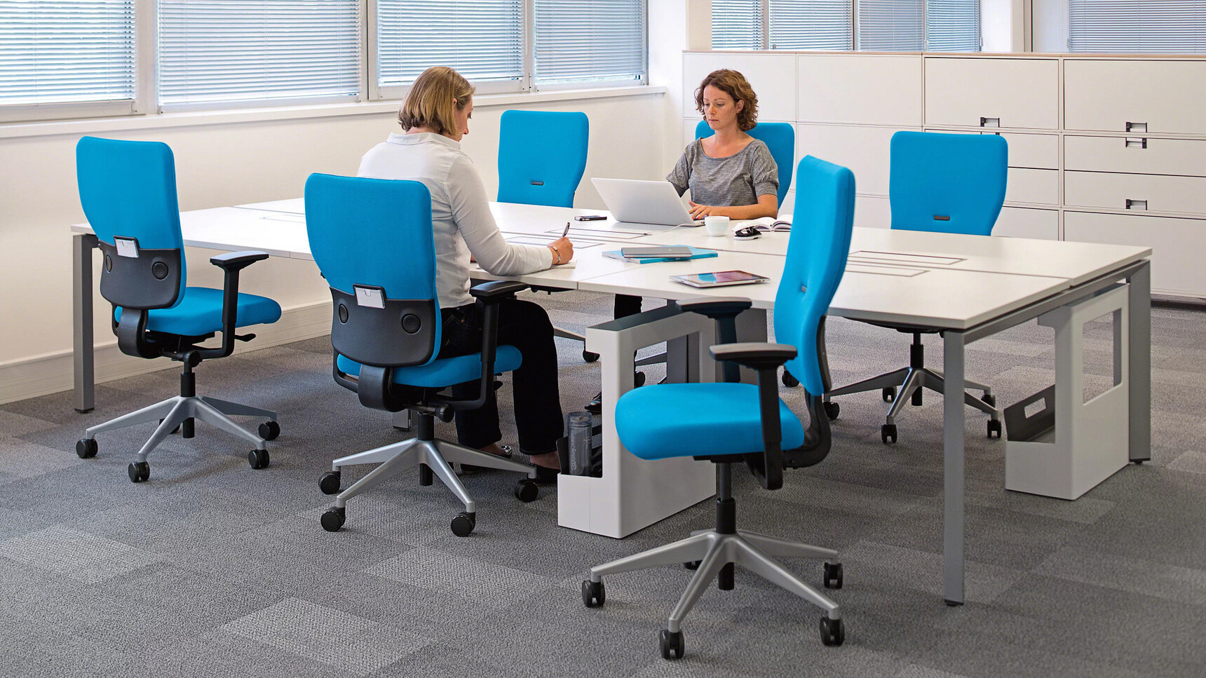 Steelcase Let's B High Back Office Chairs Blue Upholstery At Bench Desk In Office Environment