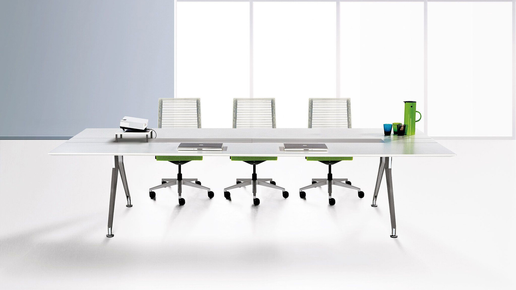 Steelcase 4.8 Barrel Conference Table With White Finish And Silver Aluminium Legs With Three Steelcase Office Chair With White Backrest And Green Upholstery At Desk