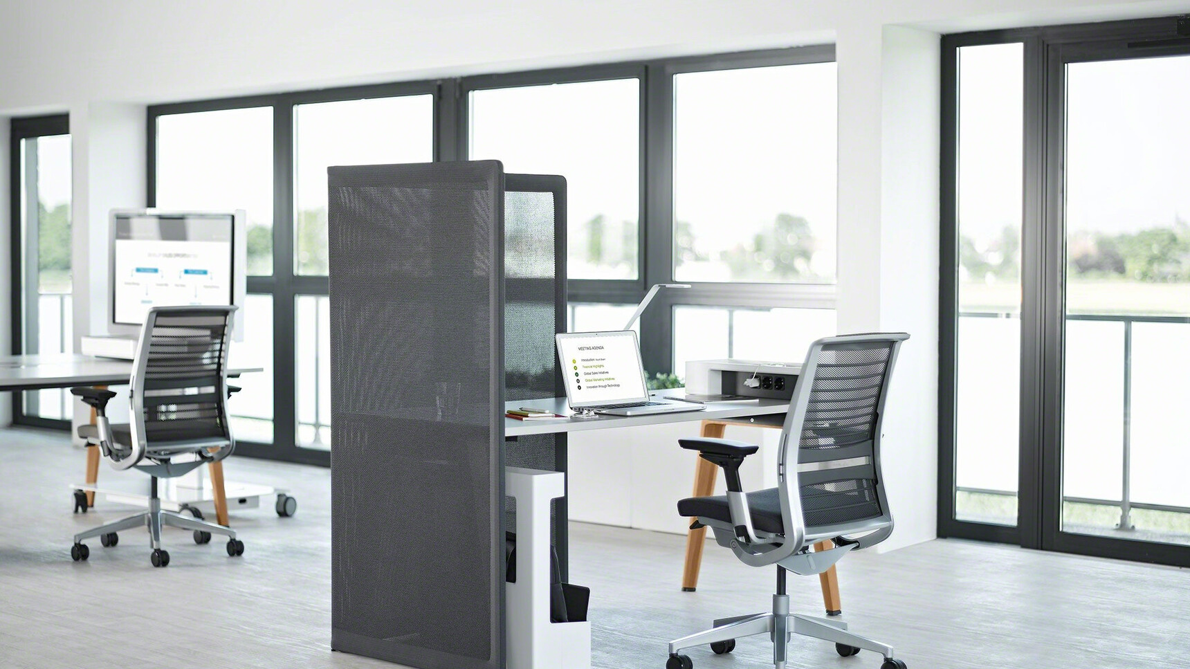 Steelcase B-Free Desk With Grey Table Top Finish And Wooden Leg Finish With Two Think 3D Knit Back Office Chairs With Grey Frame And Black Backrest And Upholstery