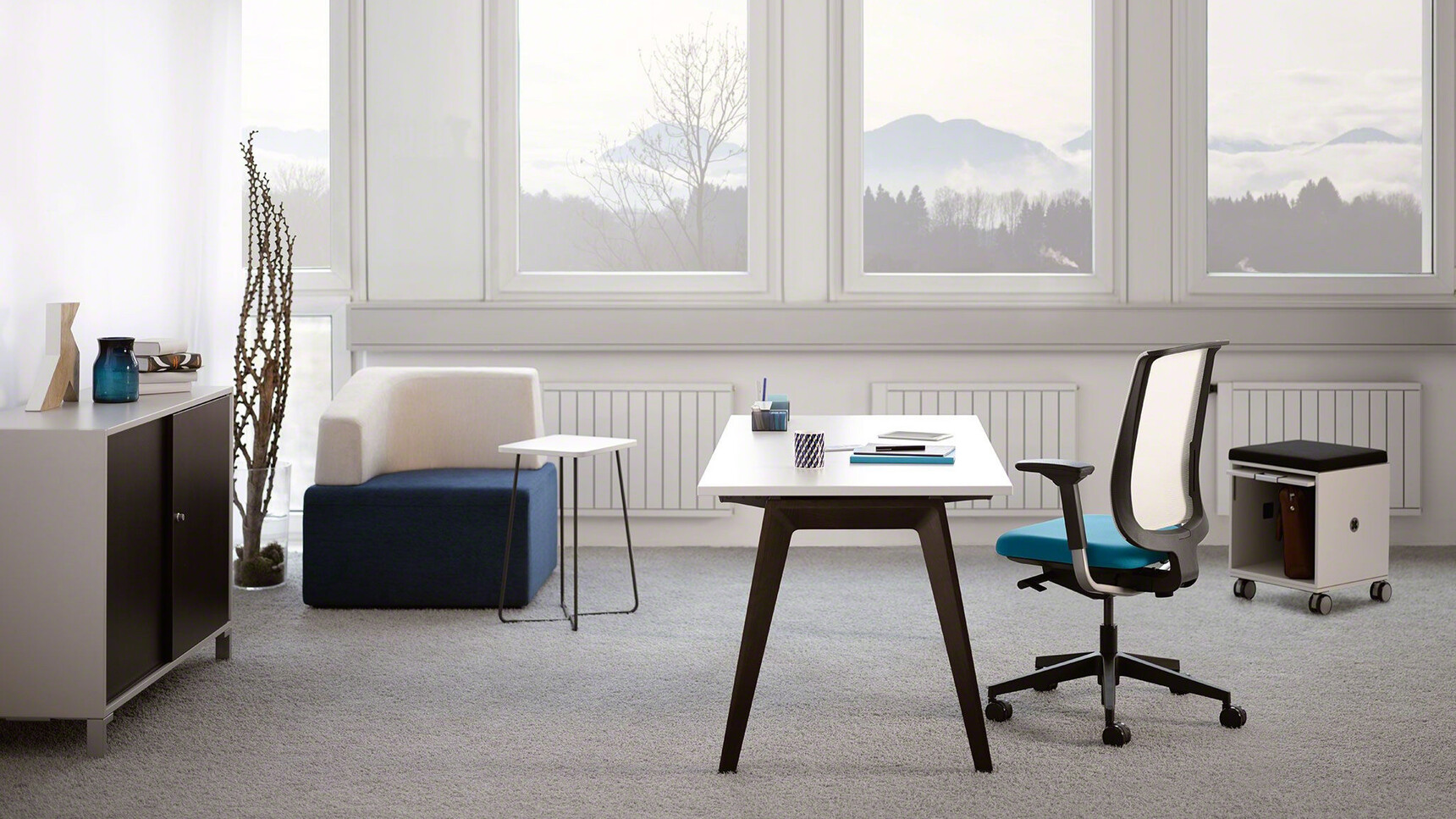Steelcase B-Free Desk With White Table Top Finish And Black Leg Finish With Reply Air Mesh Back Office Chair With White Backrest And Blue Upholstery In Office
