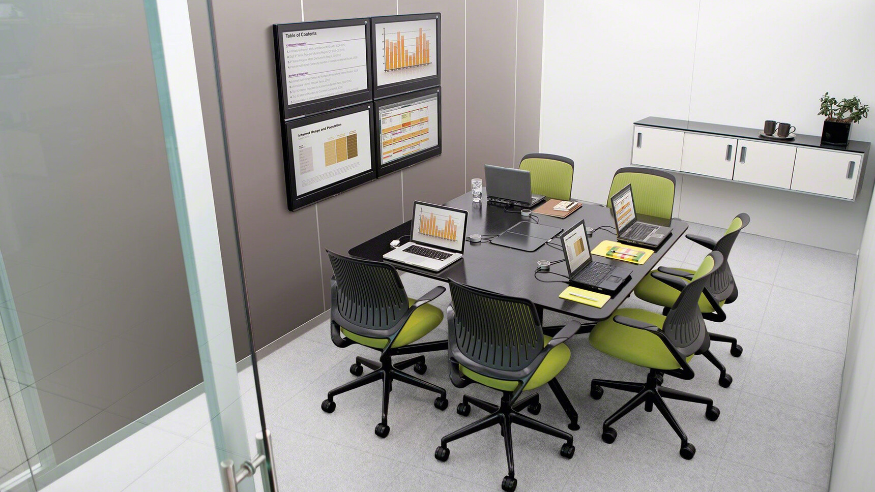 Six Steelcase Cobi Office Chairs With Black Frame And Green Upholstery And Black Base On Castors At Desk