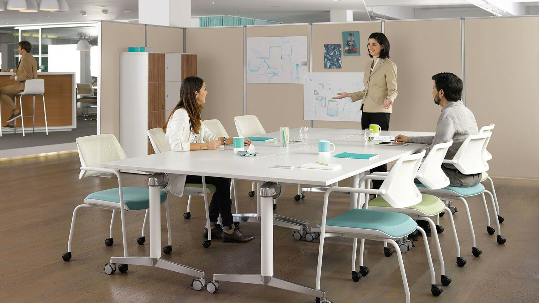Two Steelcase Flip Top Twin Rectangular Meeting Tables With  White Aluminium Legs And White Finish And Eight Qivi Four Leg Base Conference Chairs on Castors With Three People Using Meeting Room