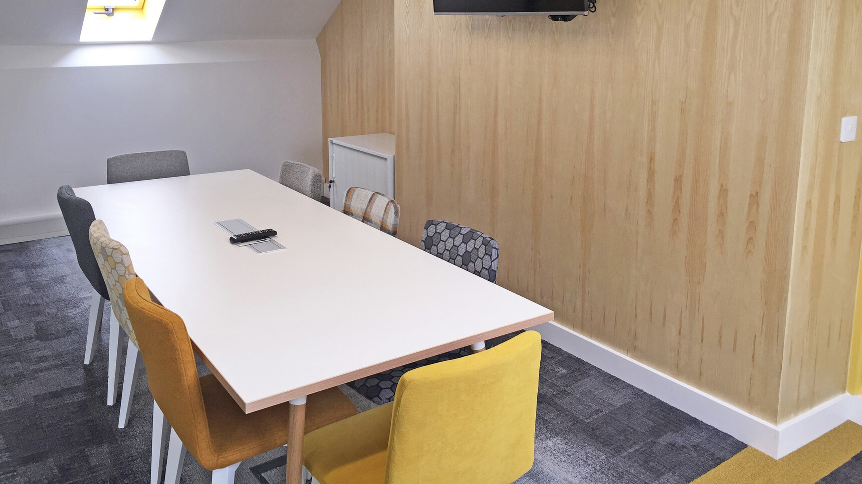 Elite Office Furniture Multiply Wood Meeting Chairs With Four Leg Base Closed Back At Table With White Frame In Office Setting