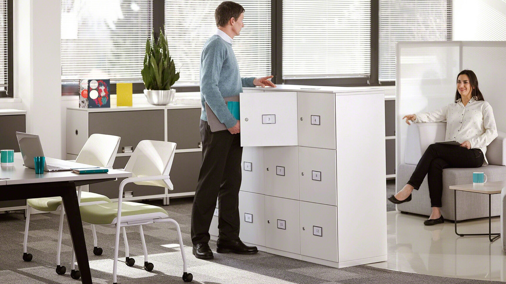 Two Steelcase Qivi Four Leg Base Conference Chairs on Castors With White Base Finish And Green Upholstery In Office Environment