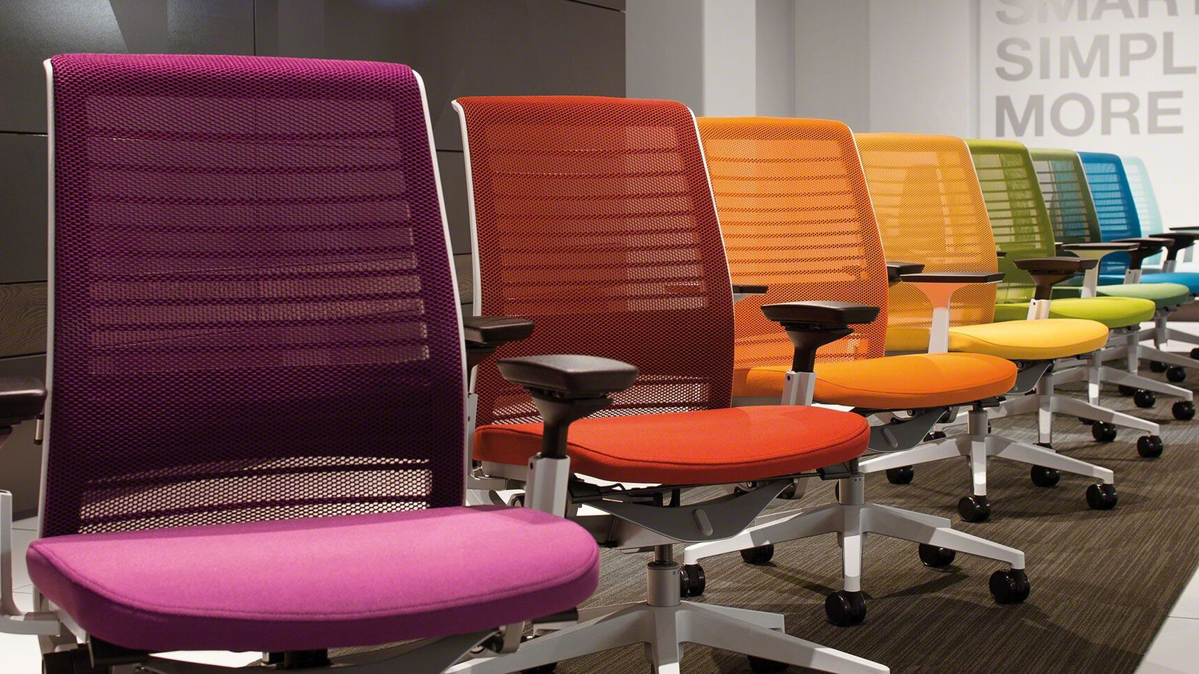 Eight Steelcase Think 3D Knit Back Office Chairs In Purple Red Orange Yellow Light Green Dark Green Blue And Light Blue Upholstery Detail Image