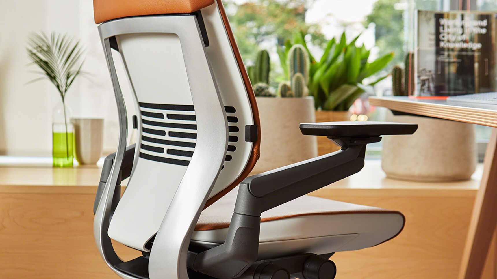 Steelcase Gesture Wrapped Back Leather Office Chairs With Brown Upholstery And Black Armrest And Grey And White Frame At Desk Detail Image