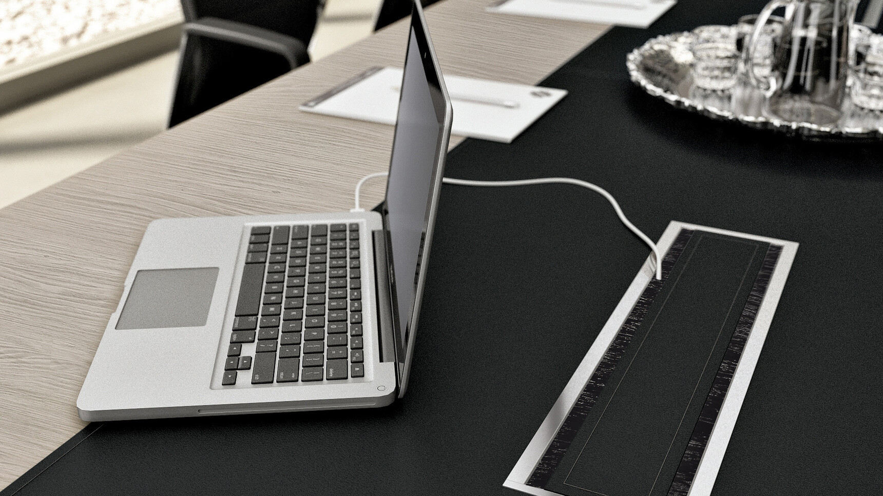 X10 Wood Veneer Boardroom Table with Leather Inlay With Light Wood Finish And Black Leather Inlay And Black Aluminium Flap For Cable Management Showing Laptop Plugged In To Cable Management Tray Detail Image