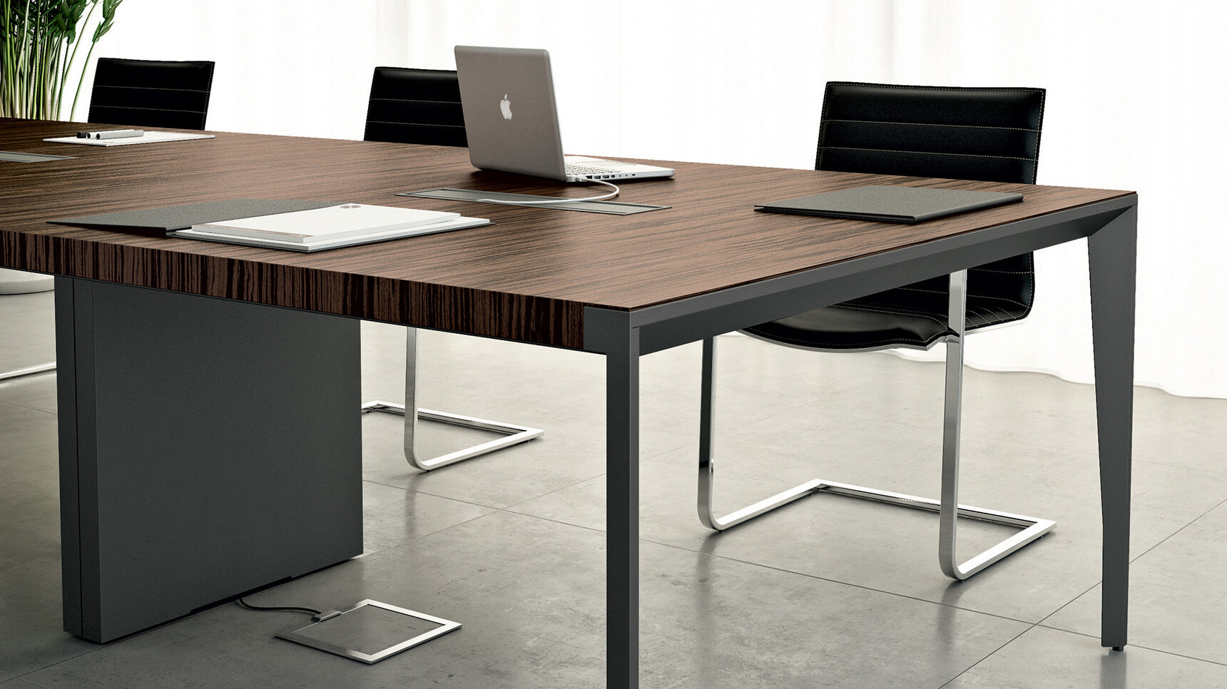 Quadrifoglio X9 Wood Veneer Boardroom Table With Dark Wood Finish And Two Black Aluminium Flaps With Black Legs And One Inset Legs In Black Finish And Three Chairs Detail Image