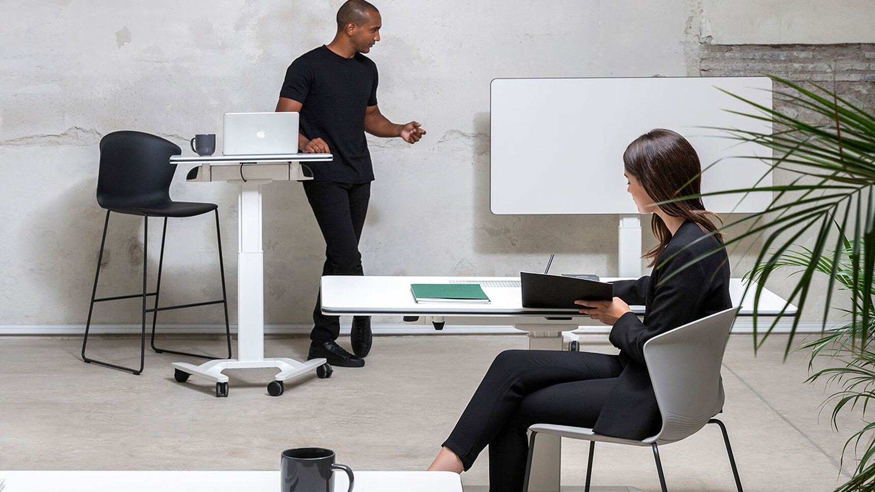Actiu Talent Series 500 Height Adjustable Desk With Flip Top Table & Writable Surface Showing Surface Being Used In Office Setting