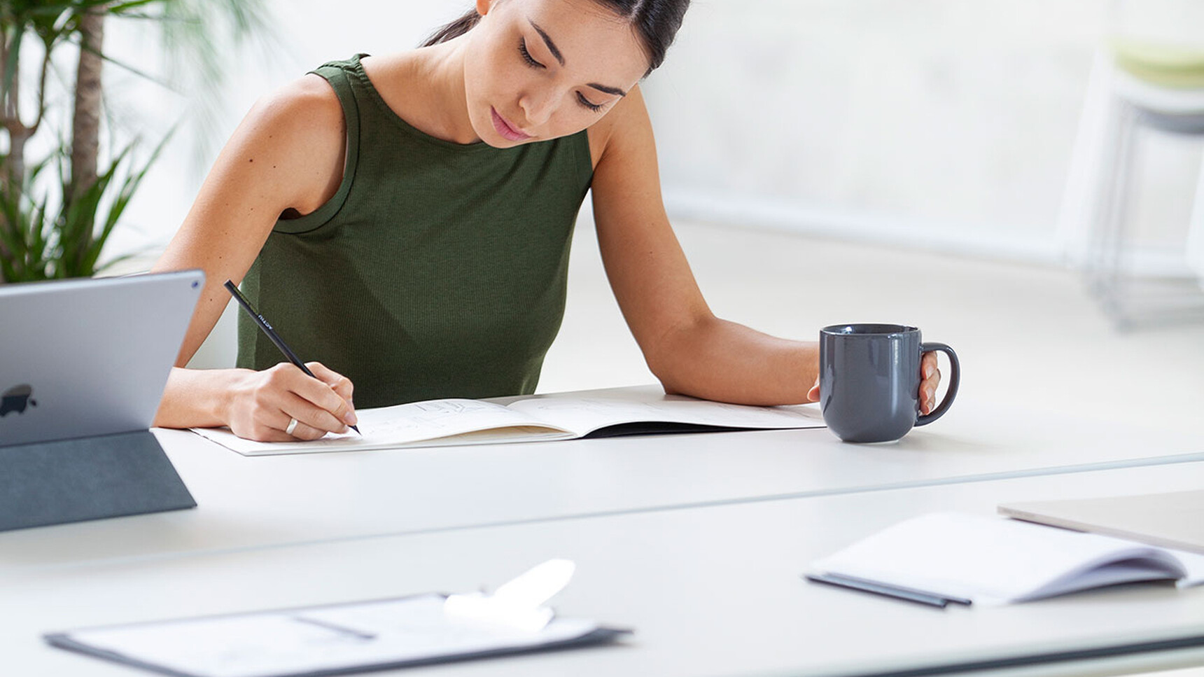 Actiu Talent Series 300 Flip Top Table With Person Writing Detail Image