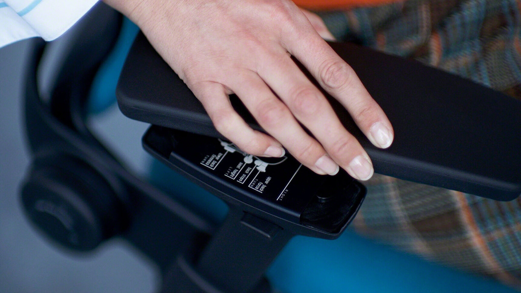 Steelcase Leap Upholstered Office Chair With Height Adjustable Fixed Arms In Black Close Up Shot With Blue Upholstery
