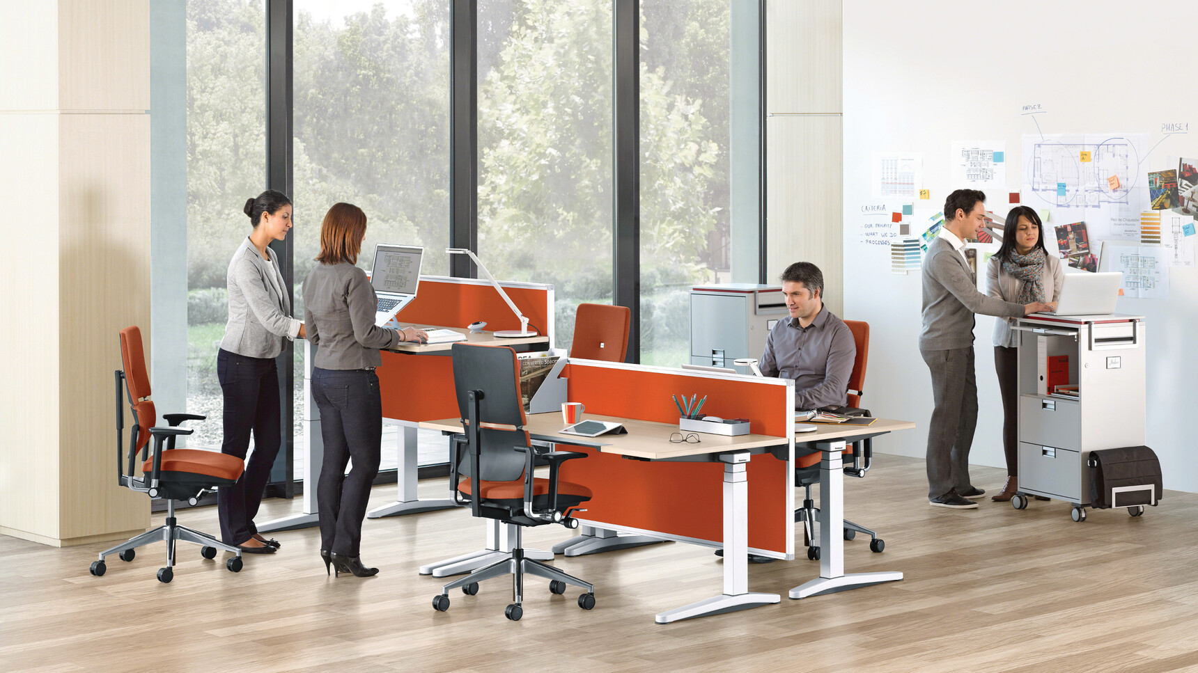 Four Steelcase Ology Height Adjustable Desks with Active Touch White Leg Wood Top Orange Screens Four Please Office Chairs Orange Upholstery At Desk
