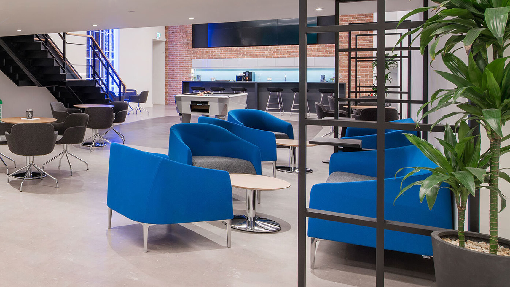 Several Manta Armchair Blue Upholstery In Lounge Setting