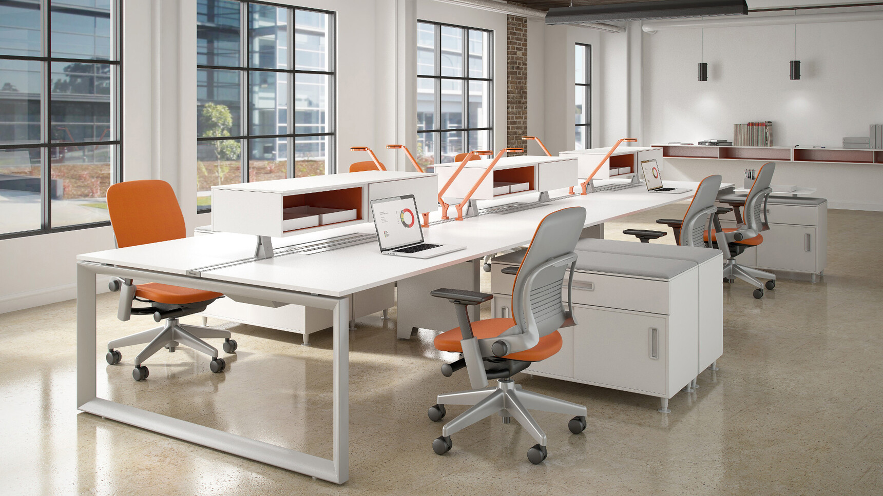Steelcase Frameone Loop Leg Bench Desk With White Table Top Finish And Grey Metal Leg With Six Leap Upholstered Office Chairs With Orange Upholstery And Grey Frame And Leg Finish On Castors At Desk