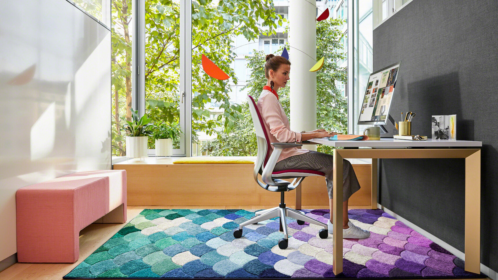 Steelcase Frameone Goalpost Leg Desk With White Top Light Brown Leg Finish SilQ Upholstered Office Chair SilQ Upholstered Office Chair Pink Upholstery Grey White Frame Grey Base