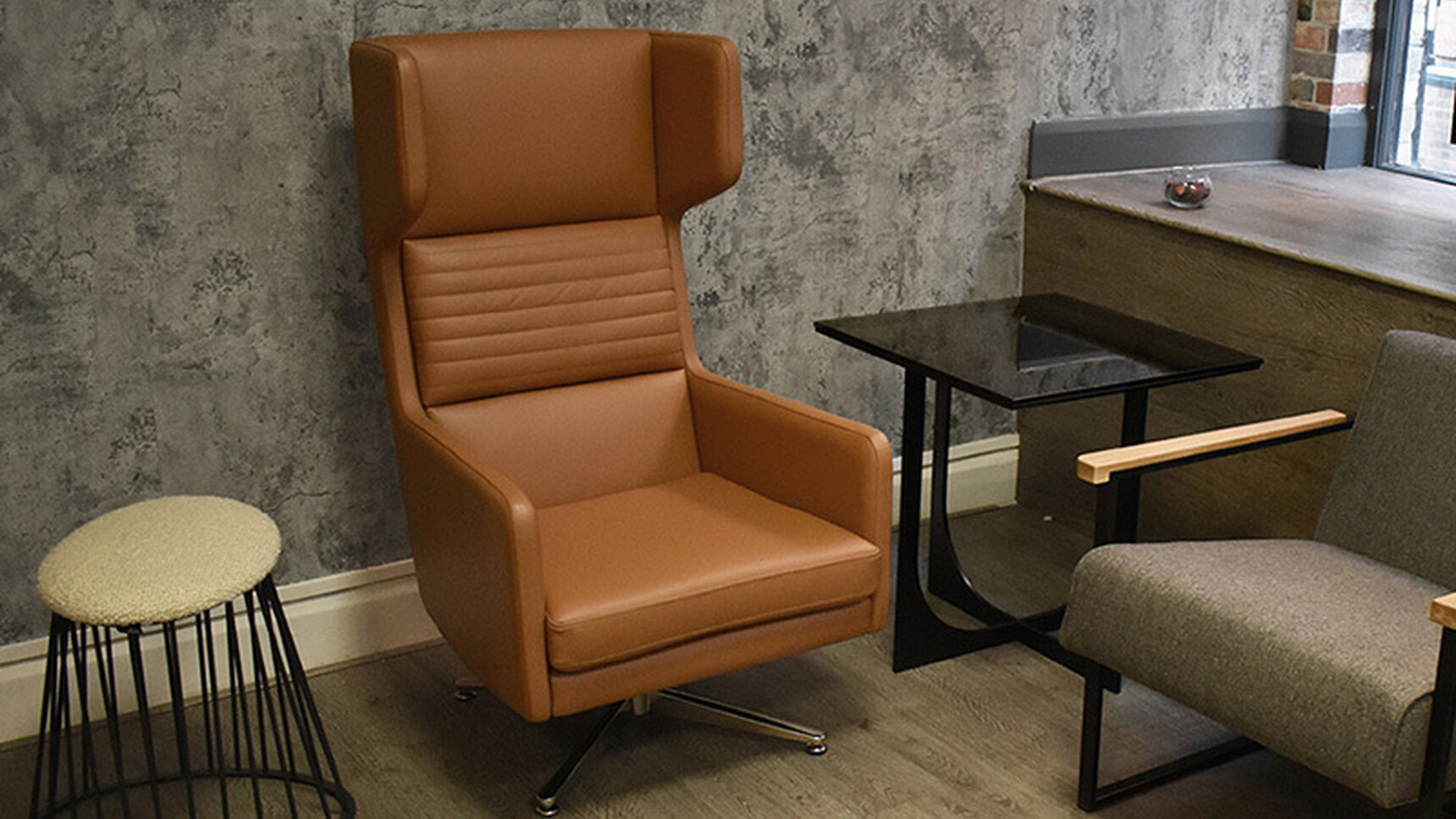 OB&B Hydde Swivel Chair Brown Upholstery In Lounge Setting